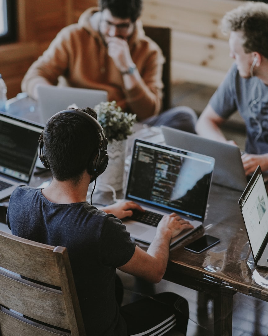Engineers working side by side on laptops