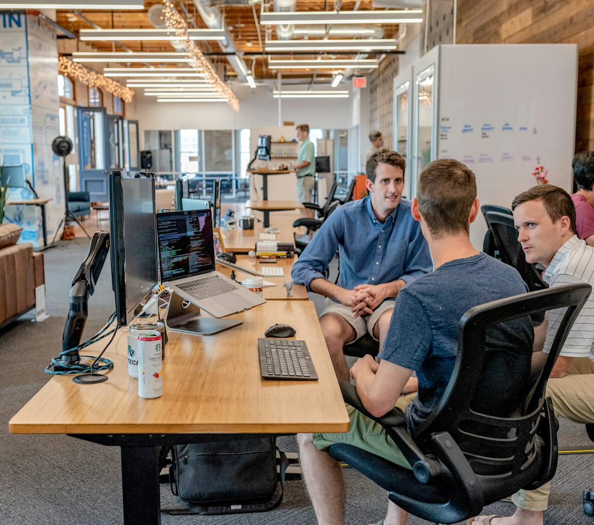 Colleagues talking through a problem in an open office